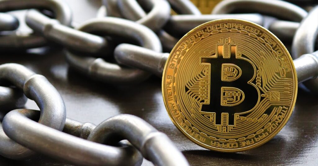 Bitcoin coins intertwined with a metal chain, symbolizing cryptocurrency and blockchain security.